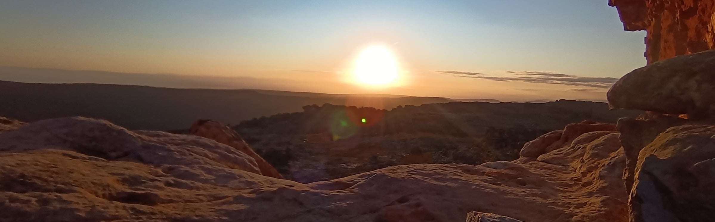 A tranquil sunset over a rocky landscape